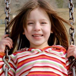 Girl smiling on swing